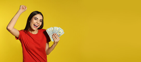 Young woman with money on yellow background, space for text. Banner design
