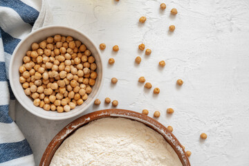 Chickpea and flour in ceramic bowl on white background