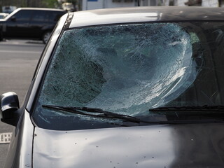 Car after a road accident with a cracked windshield