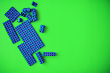 A scattering of constructor elements for children. Colored blue bricks from the puzzle.