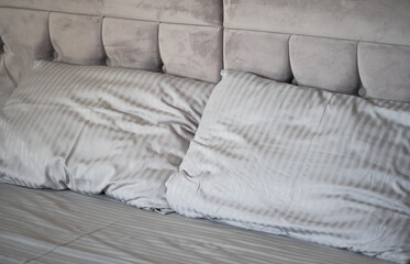 gray bed with pillows close-up