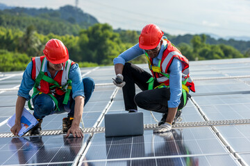 Engineer working setup Solar panel at the roof top. Engineer or worker work on solar panels or...