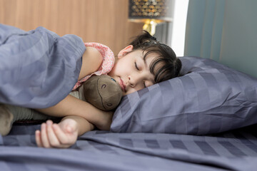 Girl sleeping on bed. Asian child sleep and sweet dream lying on bed in cozy bedroom 