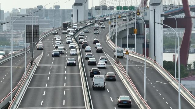 Drone aerial view of Highway and crowded traffic in rush hour. Far shot of the highway in downtown Shanghai China in day time.  Business, travel and transportation concept b-roll footage.