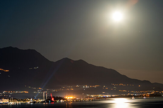 City on the coast in the light of the moon and night lights