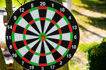 playing darts, darts in the center of the board. Red dart arrow on center of dartboard. Success,...