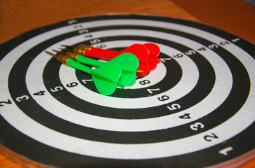 darts arrows lie on a dart board. darts game