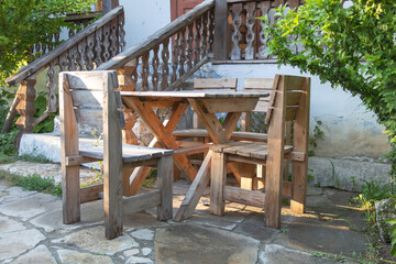 Beautiful shot of wooden rustic chairs and a table for garden