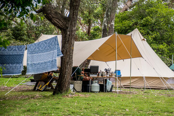Family tent setup at the campsite surrounding by bush forest in a holiday caravan parlk. Family...