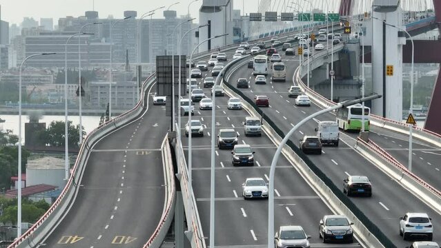 Drone aerial view of Highway and crowded traffic in rush hour. Far shot of the highway in downtown Shanghai China in day time.  Business, travel and transportation concept b-roll footage.