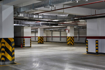 Empty underground parking...Empty business center underground parking lot  interior with concrete...