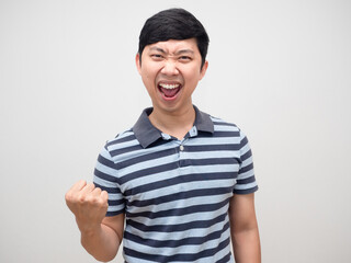 Asian man blue shirt gesture satisfy happy emotion and fist up
