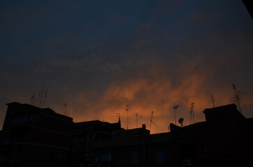 Photos of the sunset over the buildings in Rome