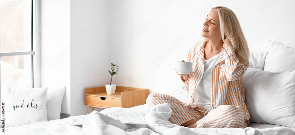 Poster Morning of beautiful mature woman drinking coffee in bedroom