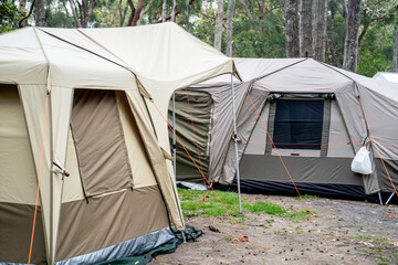 Large family tents on a campsite campground. Group camping vacation. Family camping
