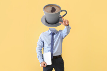 Businessman with cup of hot coffee instead of his head and laptop on yellow background