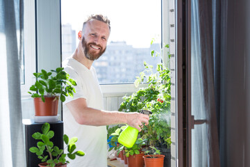 Man growing city balcony garden - obrazy, fototapety, plakaty