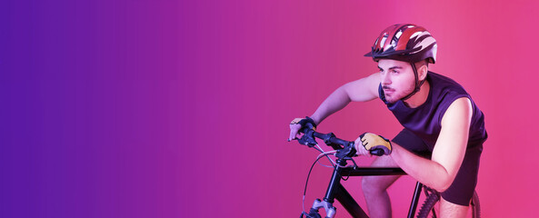 Male cyclist riding bicycle on color background with space for text. Banner for design