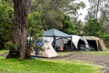 Family tent setup at the campsite surrounding by nature in caravan holiday park