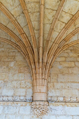 Stone arches extend out of an interior stone wall