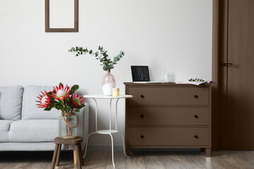 Modern room with chest of drawers, table and sofa