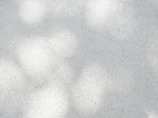 Shadow and light from sunlight dappled on flooring marble stone wall texture background.