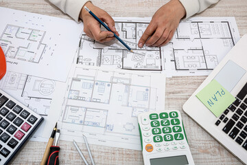 designer architect corrects his sketches of the plan of a new house outside the city.