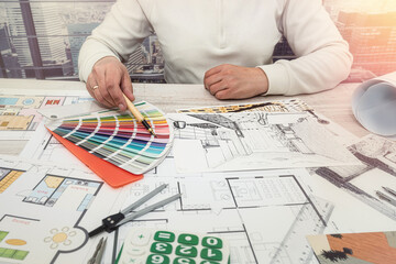 Art designer man chooses colors for office work.