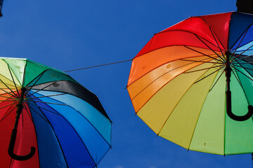 Two colorful open umbrellas protect against the sun