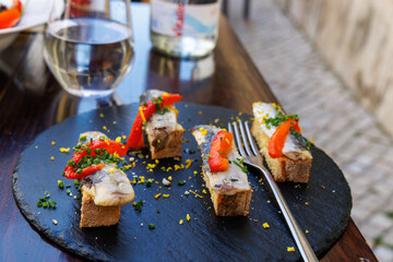 An appetizer of sardine fish on toast as a meal at a tapas wine bar