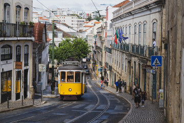 A yellow tram on a Lisbon street in Portugal
