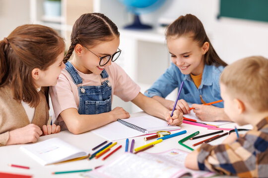 Diligent girl speaking with classmates