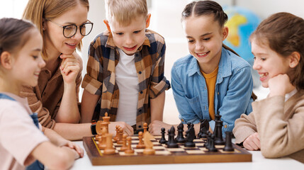 Woman teaching kids to play chess