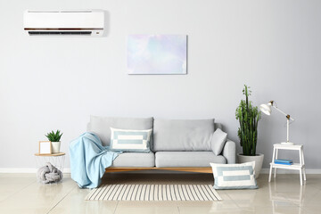 Interior of stylish living room with sofa and air conditioner