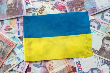 Ukrainian hryvnia banknotes on the national flag of Ukraine.