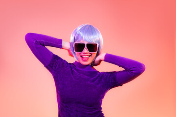 Cyber punk girl concept, happy asian woman in purple sweatshirt wearing sunglasses posing like robot. isolated on red color background