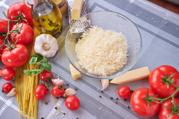 grated parmesan cheese in glass bowl at domestic kitchen