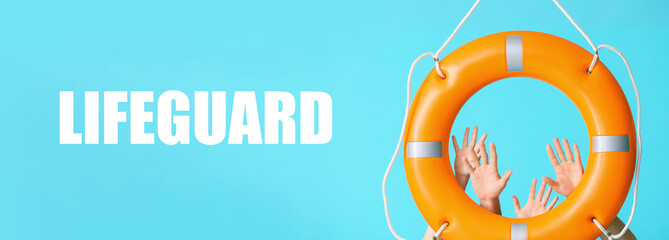 Many human hands with lifebuoy and word LIFEGUARD on light blue background