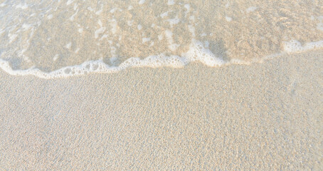 Fototapeta na wymiar Close-up of white sand, washed by soft sea waves