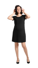 Fototapeta premium Young pregnant woman in headphones on white background