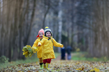 Children are walking in the autumn park