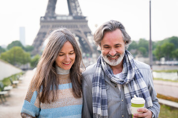 Happy mature couple in front of Eiffel tower, Paris, France