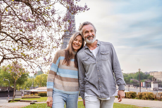 Happy mature couple walking together in front of Eiffel tower, Paris, France
