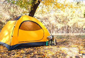 Tourist's backpack with survival kit near tent in forest © Pixel-Shot