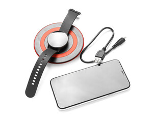 Wireless charger pad, smartwatch and mobile phone on white background