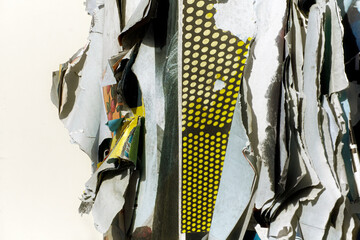 Torn advertisements hanging on advertising column