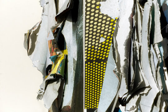 Torn advertisements hanging on advertising column