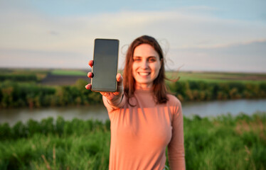 Young woman showing smart phone on weekend