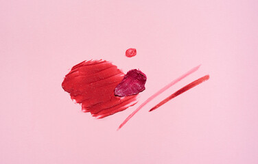 Swatches of shimmery shades of red and pink lipstick. Texture of decorative cosmetics