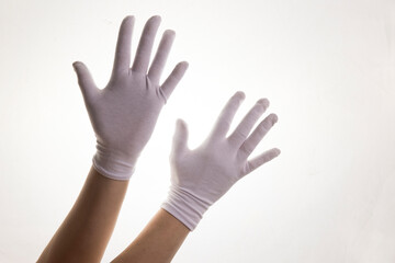 Hands gesticulating in white textile gloves on a white background